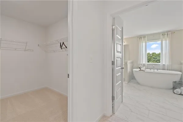 a bathroom with a granite countertop sink mirror and a bathtub