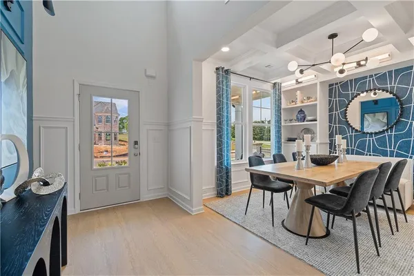 a view of a dining room with furniture and chandelier