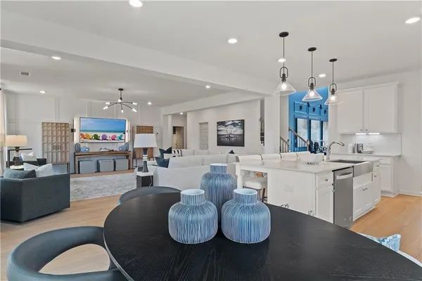 a living room with kitchen island furniture and a chandelier