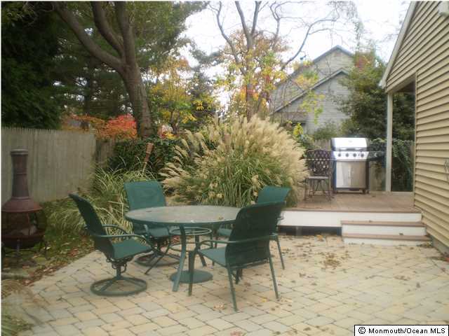 539 Woodland Avenue Brielle, NJ 08730 - Photo 15 of 20 a view of a patio with table and chairs and potted plants