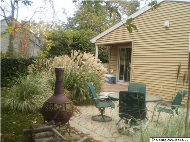 539 Woodland Avenue Brielle, NJ 08730 - Photo 18 of 20 a front view of house with yard outdoor seating and covered with trees