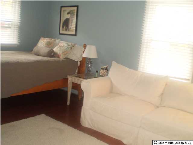 539 Woodland Avenue Brielle, NJ 08730 - Photo 7 of 20 a bed sitting in a bedroom next to a window