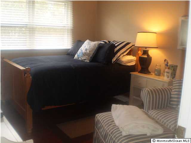 539 Woodland Avenue Brielle, NJ 08730 - Photo 9 of 20 a bedroom with a bed and a mirror