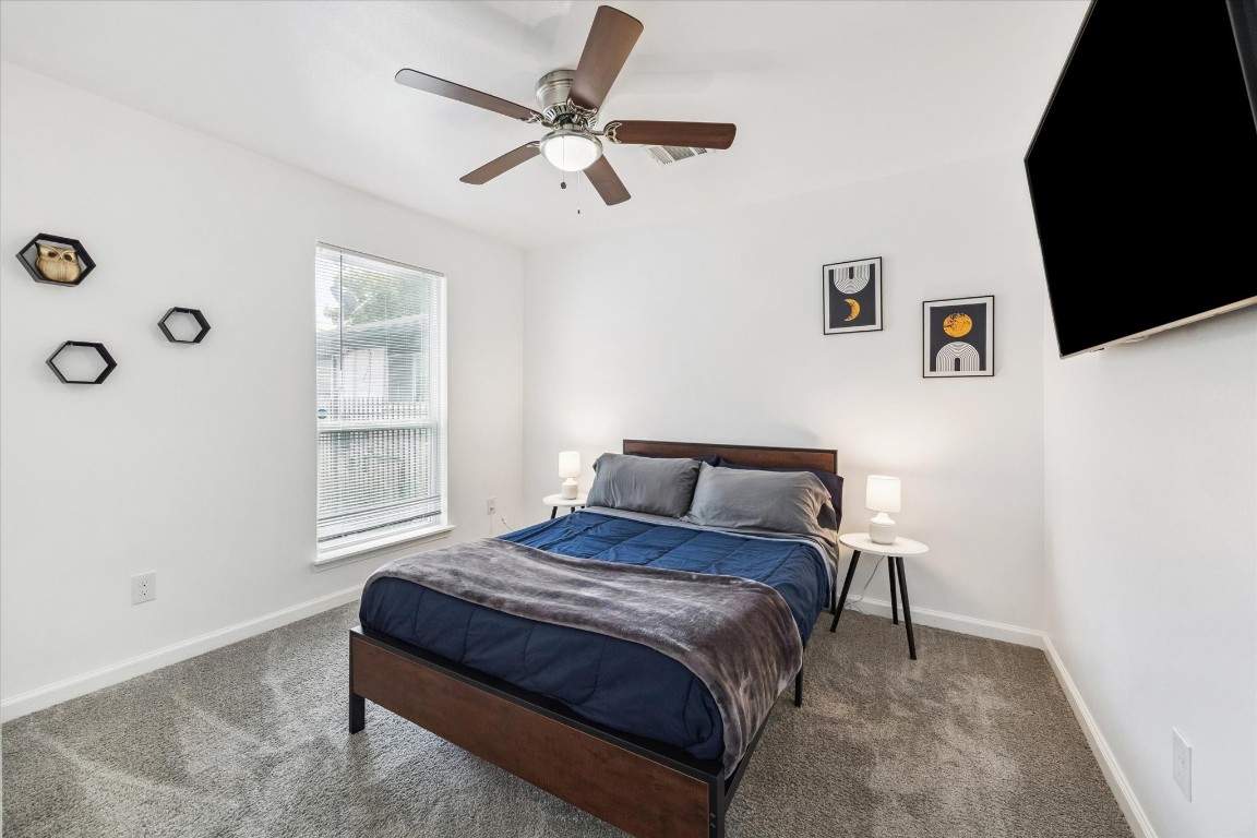 2631 Stevens Street Houston, TX 77026 - Photo 11 of 25 a bedroom with a bed and a tv on the dresser