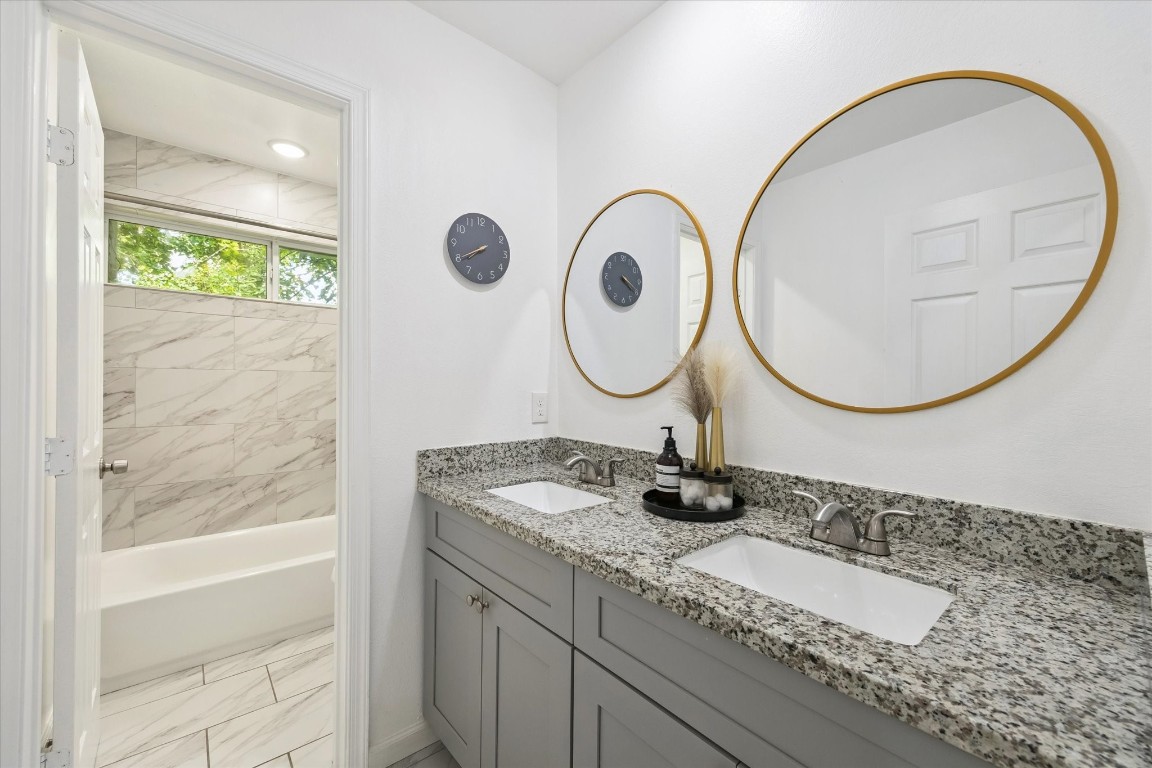 2631 Stevens Street Houston, TX 77026 - Photo 12 of 25 a bathroom with a granite countertop sink and a mirror