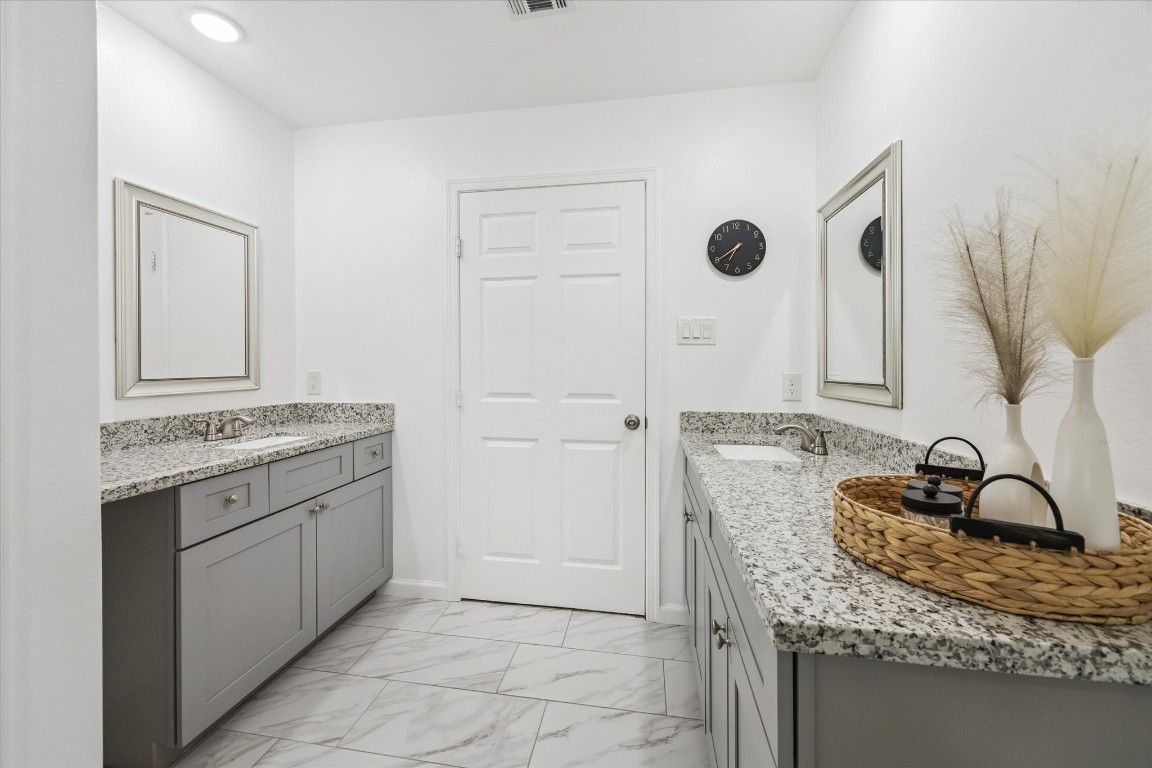 2631 Stevens Street Houston, TX 77026 - Photo 17 of 25 a bathroom with a granite countertop sink and a mirror