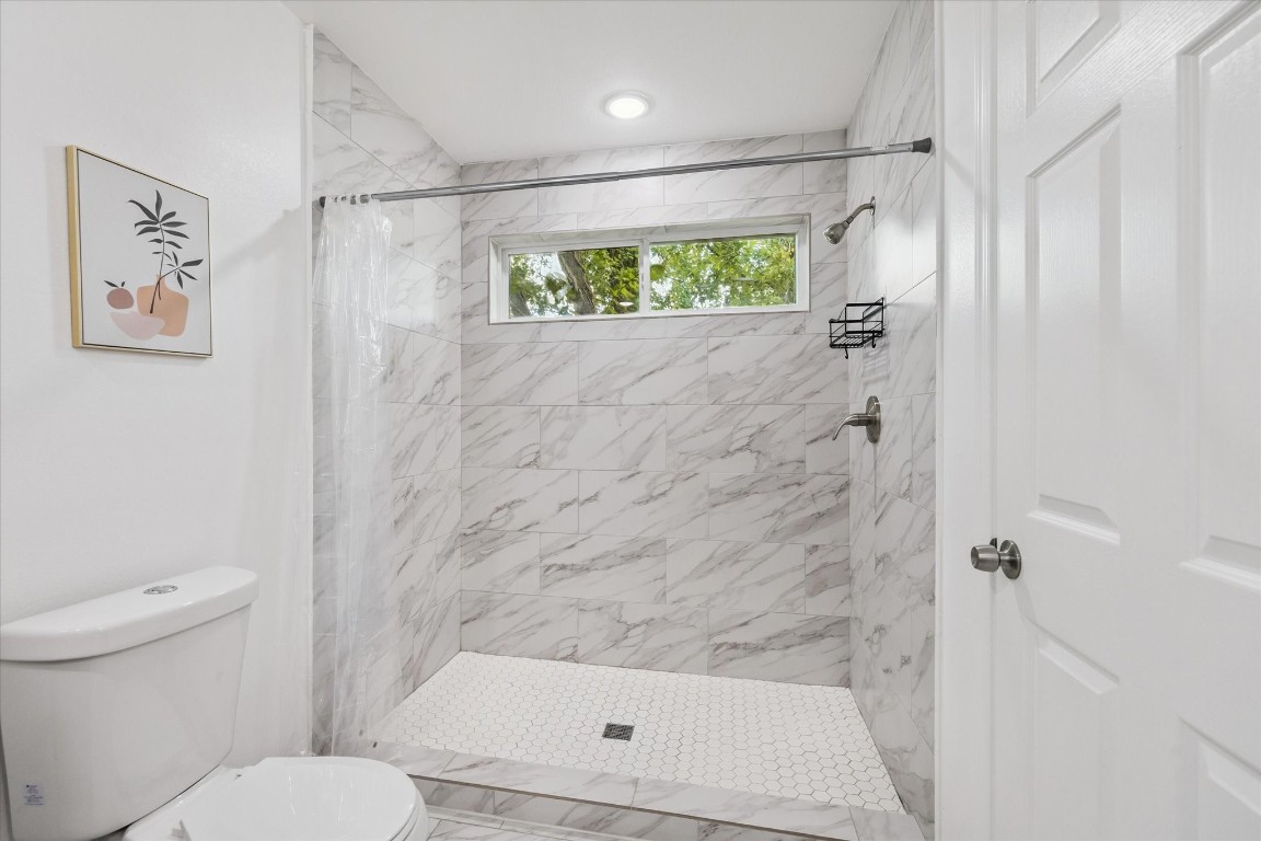 2631 Stevens Street Houston, TX 77026 - Photo 19 of 25 a bathroom with a shower and a toilet