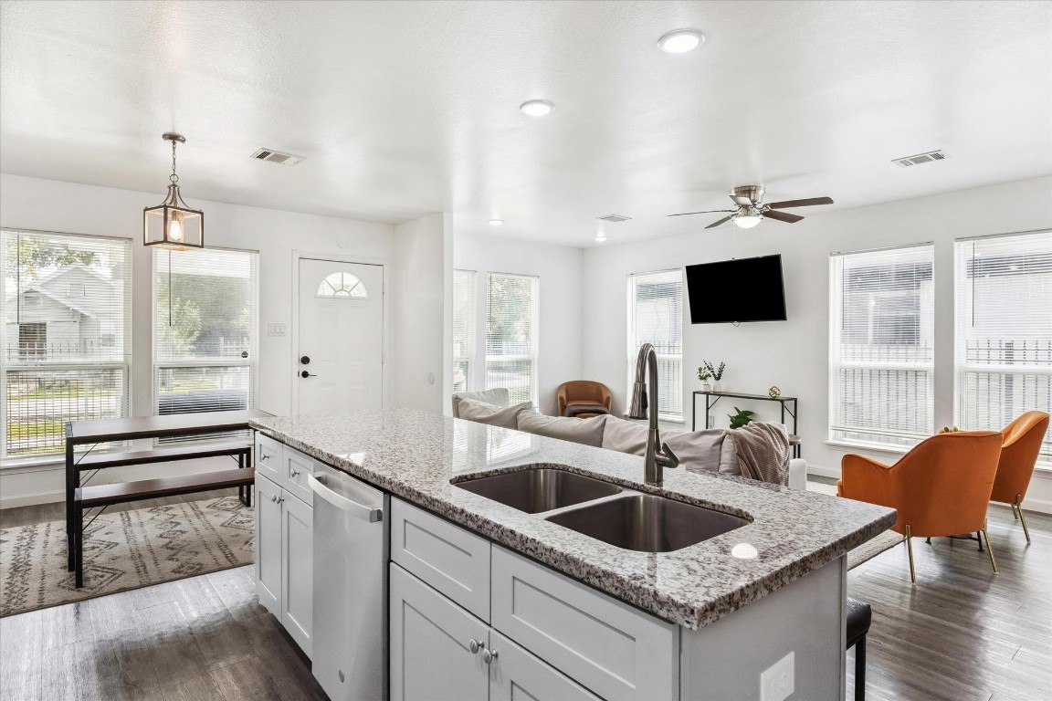 2631 Stevens Street Houston, TX 77026 - Photo 5 of 25 a kitchen with granite countertop a sink and white cabinets