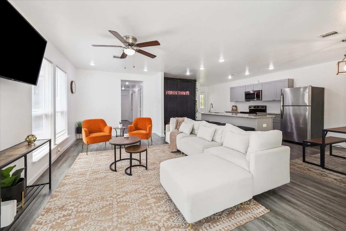 2631 Stevens Street Houston, TX 77026 - Photo 9 of 25 a living room with furniture a flat screen tv and kitchen view