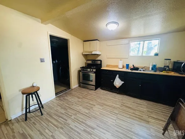 a kitchen with a sink cabinets and wooden floor