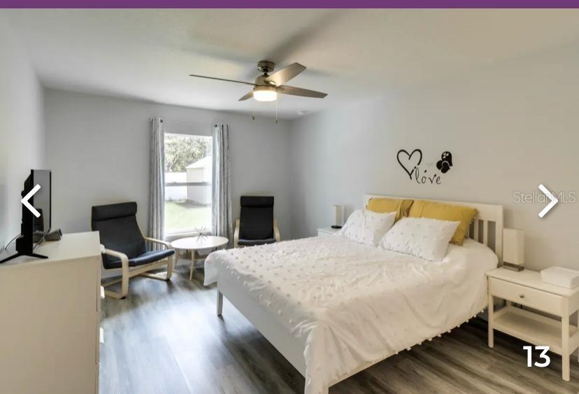 2081 Southwest 153rd Loop Ocala, FL 34473 - Photo 12 of 20 a bedroom with a bed and a chandelier