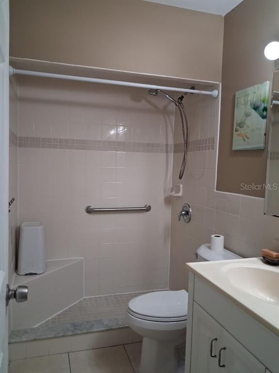4744 Azalea Drive, Unit 204 New Port Richey, FL 34652 - Photo 13 of 20 a bathroom with a sink a toilet and shower