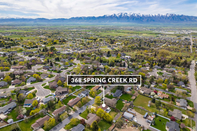368 Spring Creek Road Providence, UT 84332 - Photo 44 of 45 Aerial view of residential area with a mountain backdrop and property boundaries highlighted