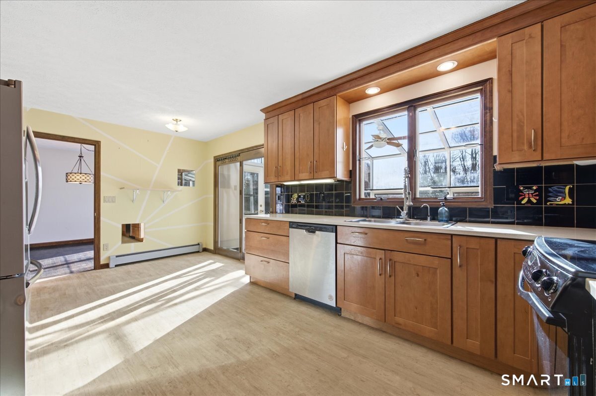 17 Inchcliffe Drive Ledyard, CT 06335 - Photo 11 of 40 a kitchen with granite countertop a stove a sink and a refrigerator