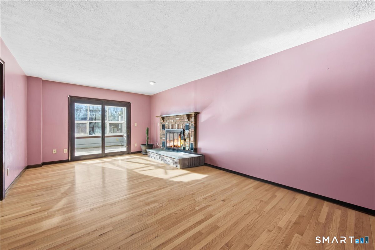 17 Inchcliffe Drive Ledyard, CT 06335 - Photo 14 of 40 a view of an empty room with wooden floor and a window