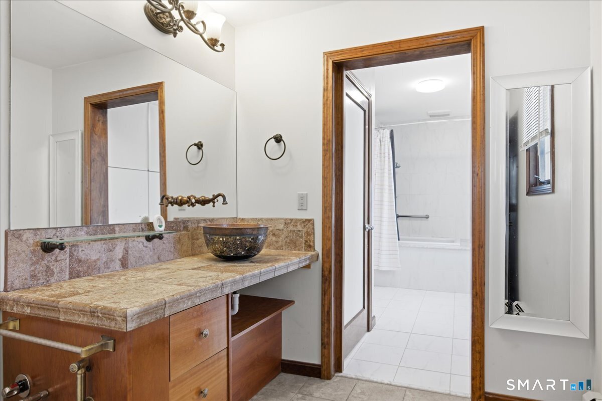 17 Inchcliffe Drive Ledyard, CT 06335 - Photo 21 of 40 a bathroom with a granite countertop sink and a mirror