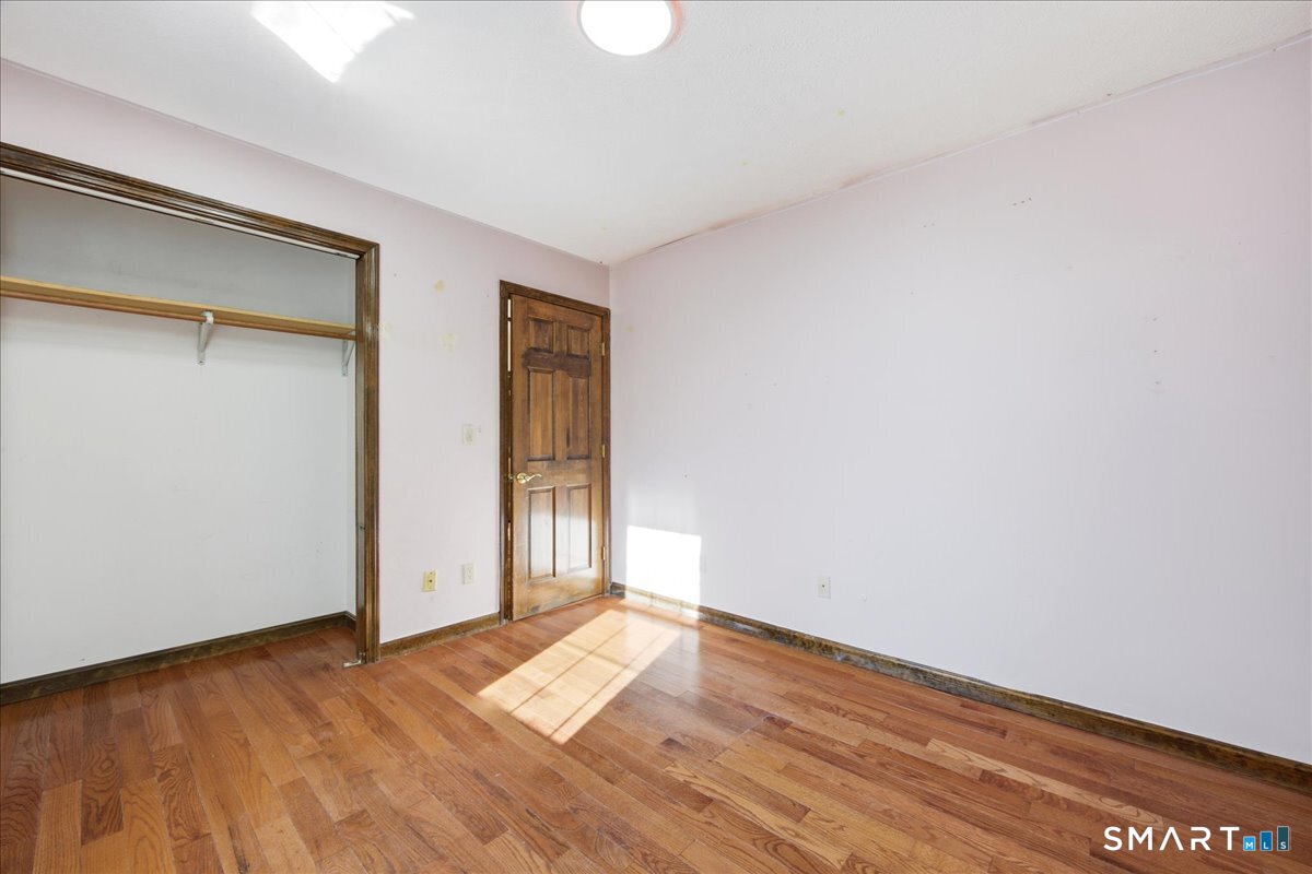 17 Inchcliffe Drive Ledyard, CT 06335 - Photo 24 of 40 a view of empty room with wooden floor and fan