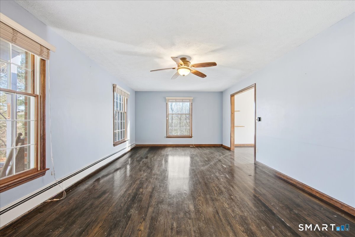 17 Inchcliffe Drive Ledyard, CT 06335 - Photo 5 of 40 a view of an empty room with a window and wooden floor