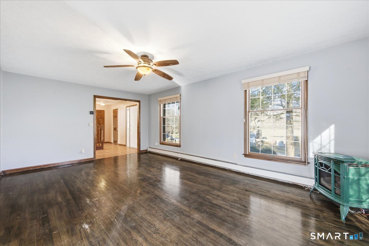 17 Inchcliffe Drive Ledyard, CT 06335 - Photo 6 of 40 a view of an empty room with a window and wooden floor