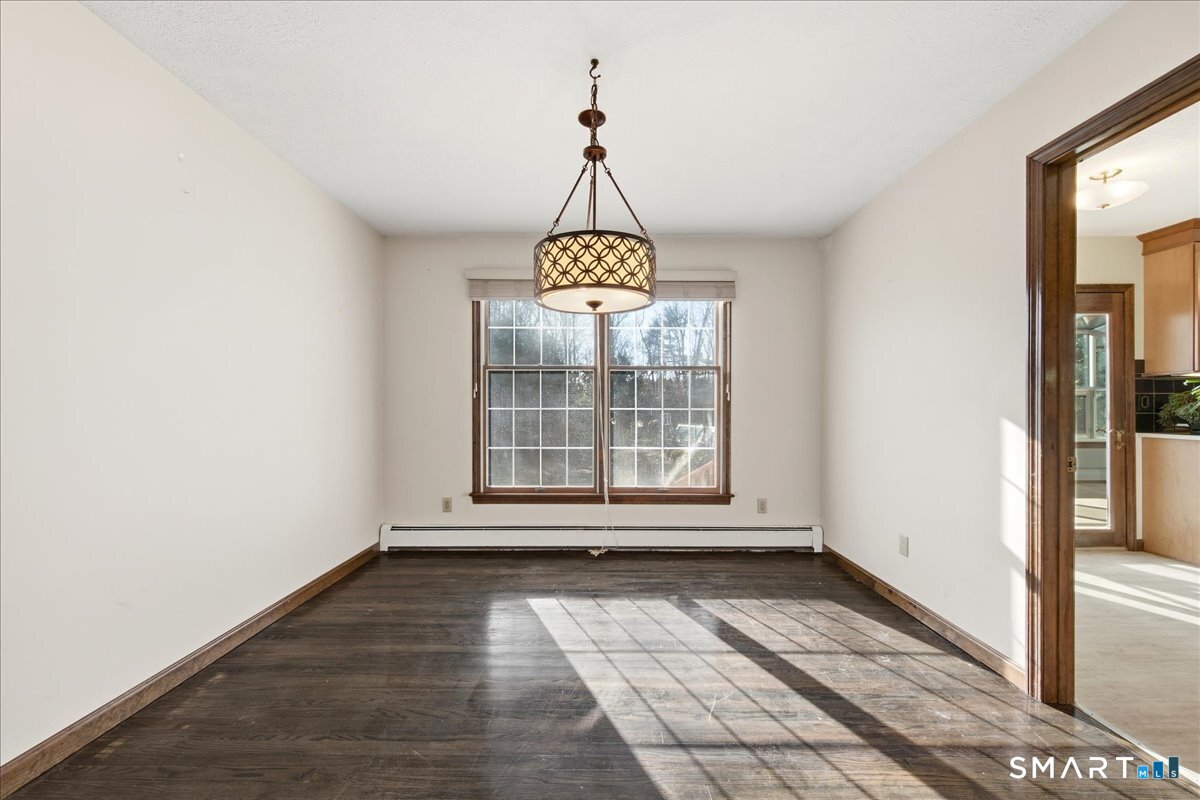 17 Inchcliffe Drive Ledyard, CT 06335 - Photo 7 of 40 a view of empty room with wooden floor and fan