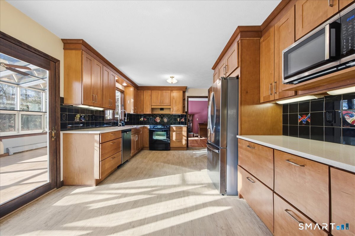 17 Inchcliffe Drive Ledyard, CT 06335 - Photo 9 of 40 a kitchen with stainless steel appliances kitchen island granite countertop a refrigerator a stove and a sink with wooden floor