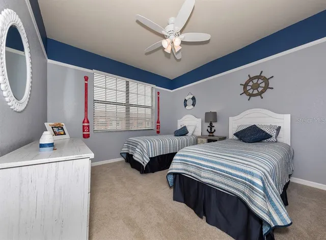 a bedroom with two beds and a chandelier