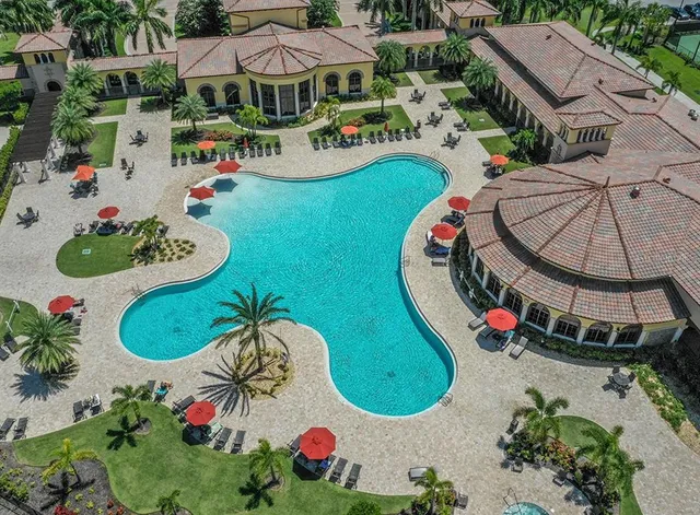 an aerial view of a swimming pool patio and outdoor seating