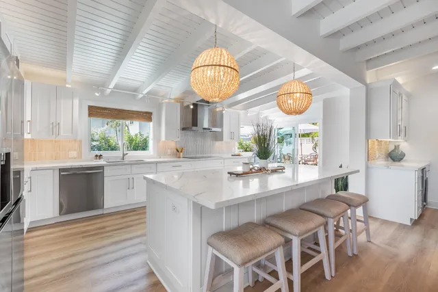 a kitchen with a dining table and wooden floor