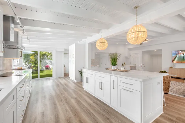 a kitchen with stainless steel appliances granite countertop a stove a sink and a wooden floors