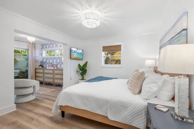 a bedroom with a bed and a chandelier