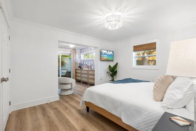 a bedroom with a bed and a chandelier