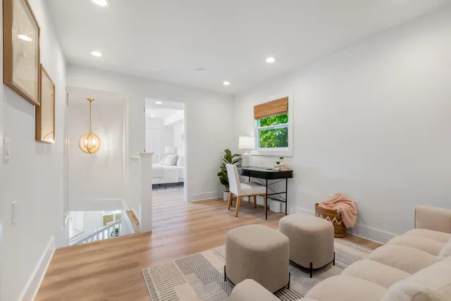 a living room with furniture and wooden floor