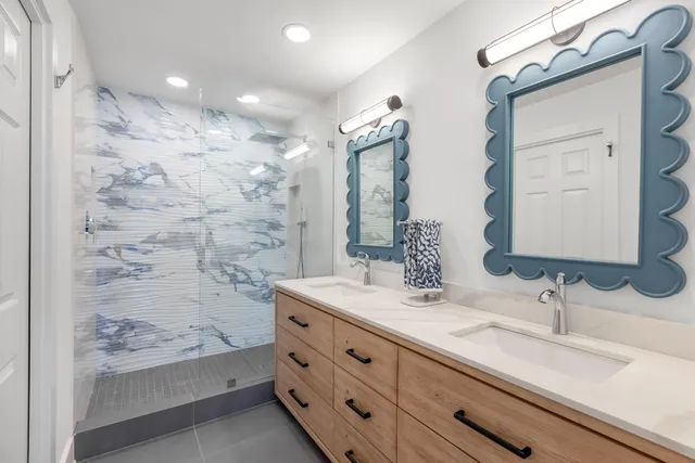 a bathroom with a sink double vanity and a mirror