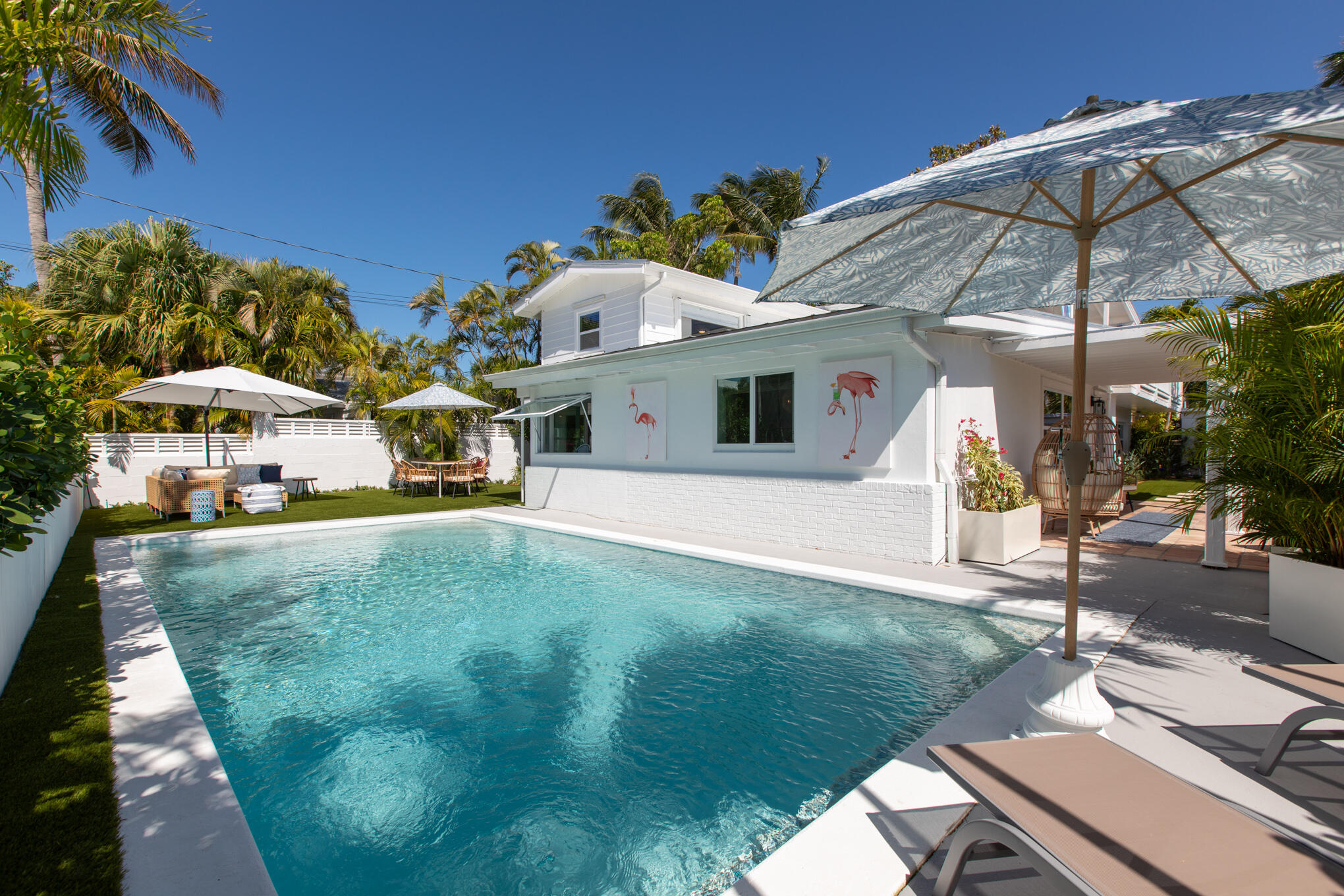 1701 Atlantic Boulevard Key West, FL 33040 - Photo 35 of 39 a view of a white house with a yard patio and furniture