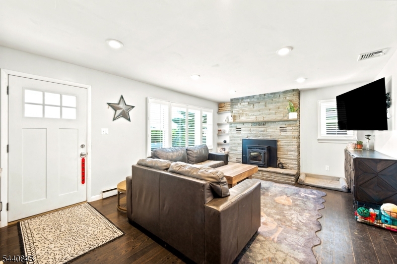 36 Forest Road Andover, NJ 07821 - Photo 49 of 50 a living room with fireplace furniture and a flat screen tv