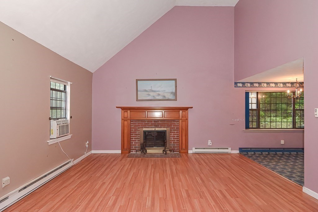 44 Cranberry Road Bourne, MA 02532 - Photo 4 of 33 wooden floor fireplace and windows in an empty room