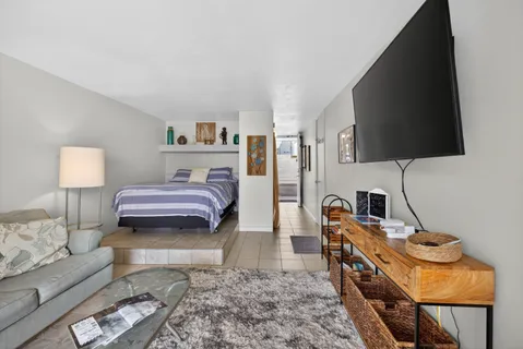 a kitchen with stainless steel appliances a refrigerator and a view of living room