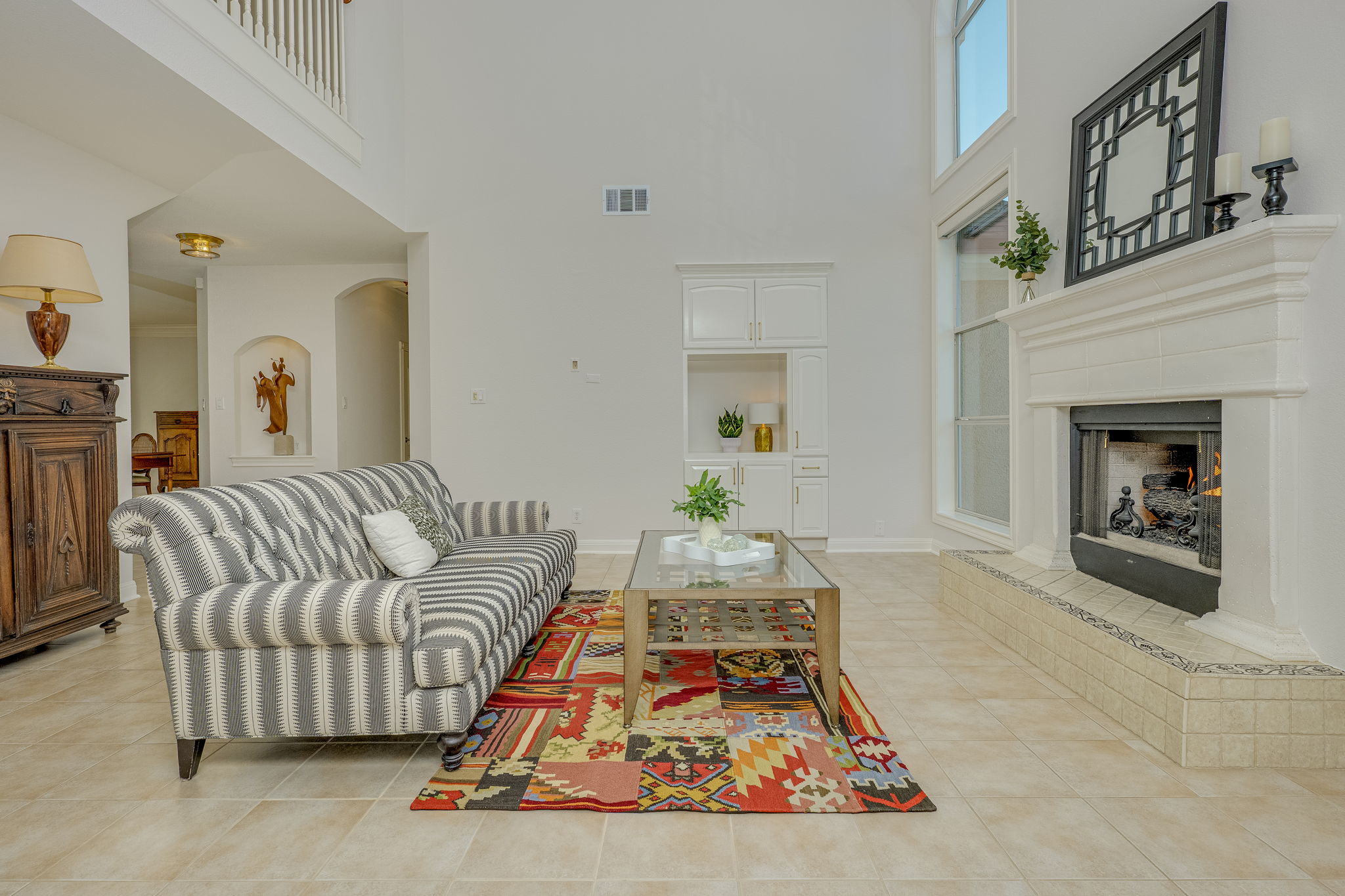 4424 Lago Viento Austin, TX 78734 - Photo 7 of 38 The family room has a gas fireplace with remote for convenience, built in cabinet space, and soaring ceilings.