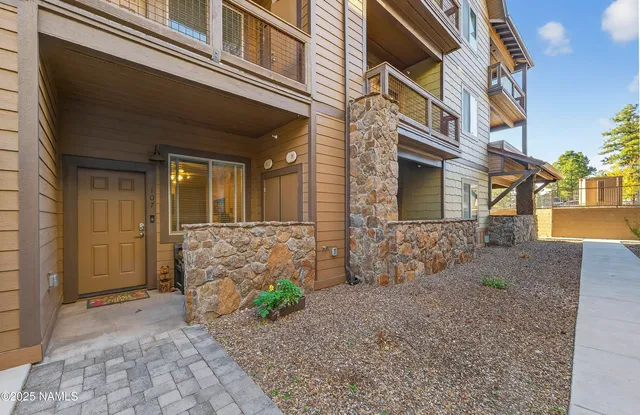 a view of a brick house with many windows