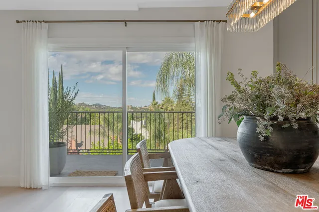 a view of a living room and a floor to ceiling window