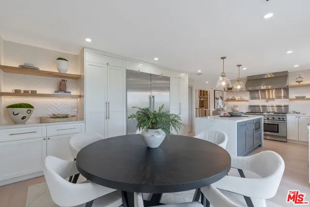 a kitchen with a table and chairs