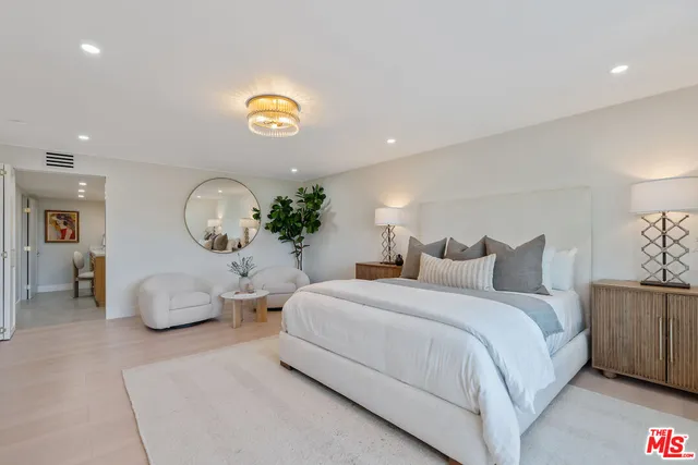a bedroom with a bed and a potted plant