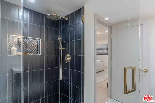 a bedroom with a bed and a painting on the wall