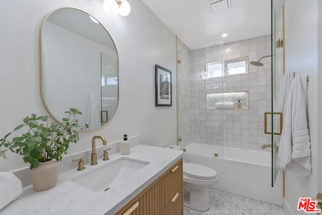 a bedroom with two beds and a painting