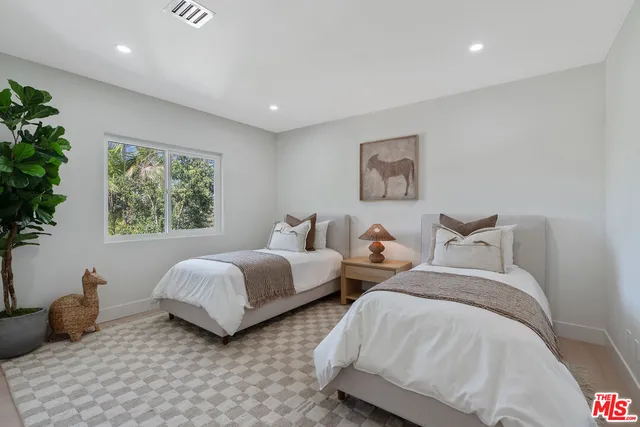 a bedroom with a bed and a night stand