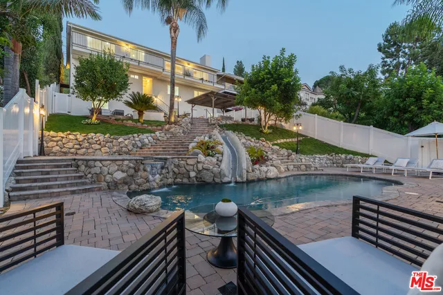 a view of a swimming pool with lounge chair