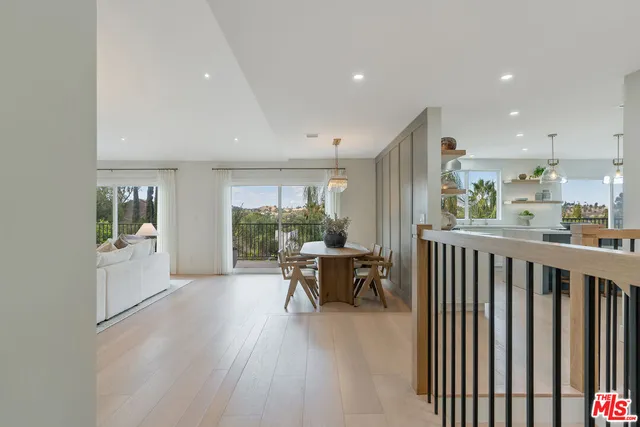 a living room with furniture a window and wooden floor