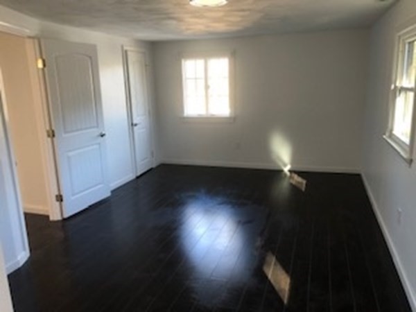 79 Searle Road Huntington, MA 01050 - Photo 6 of 14 an empty room with wooden floor and windows