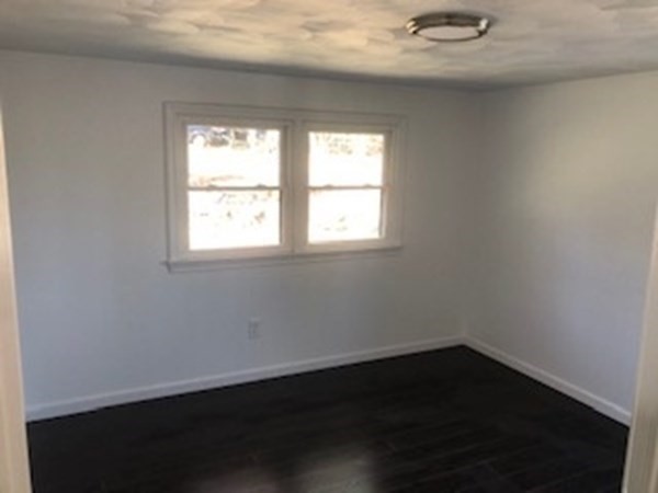 79 Searle Road Huntington, MA 01050 - Photo 7 of 14 an empty room with wooden floor and windows