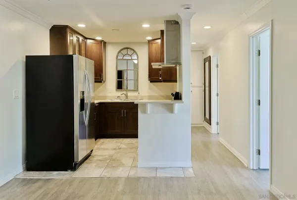 a kitchen with stainless steel appliances granite countertop a refrigerator and a sink